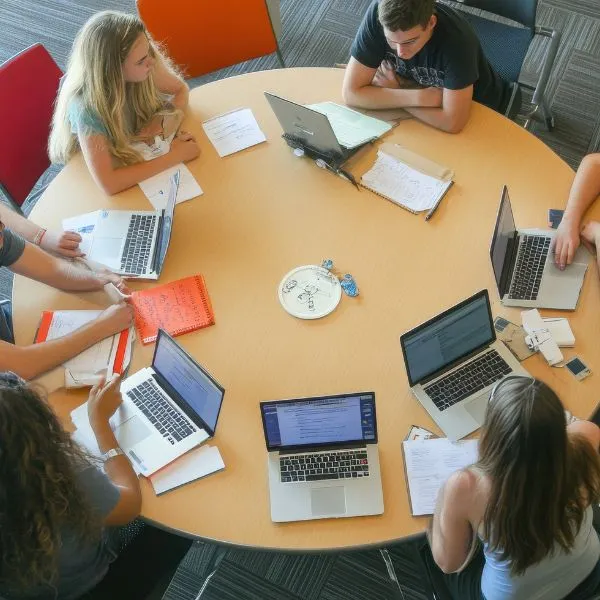 A high-angle shot of a diverse team of professionals engaged in a collaborative strategy session.